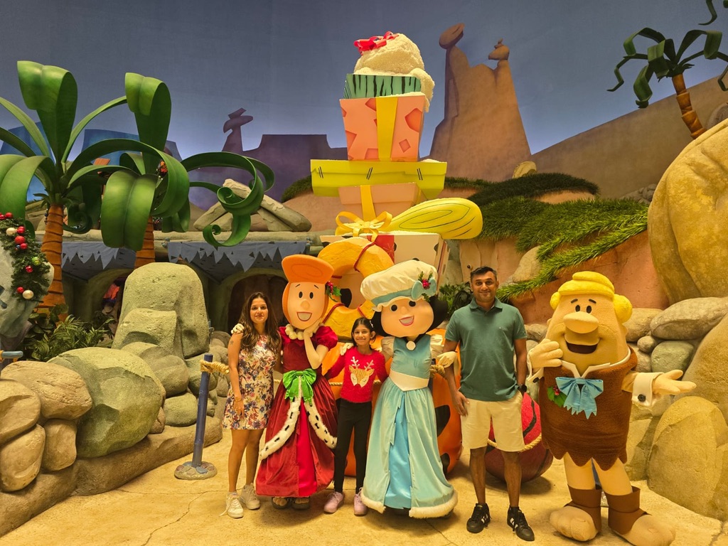 Aniket with his family at a theme park